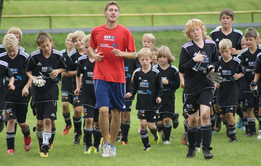 Young children playing grassroots football