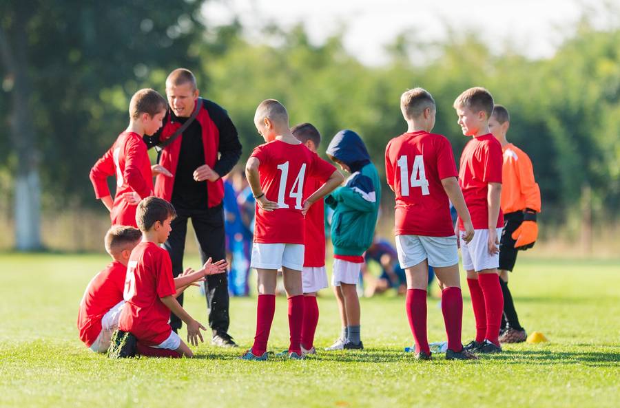 football coach with junior players