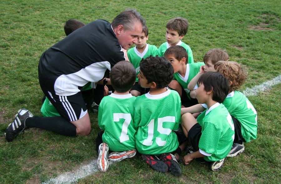 Grassroots football coach with players