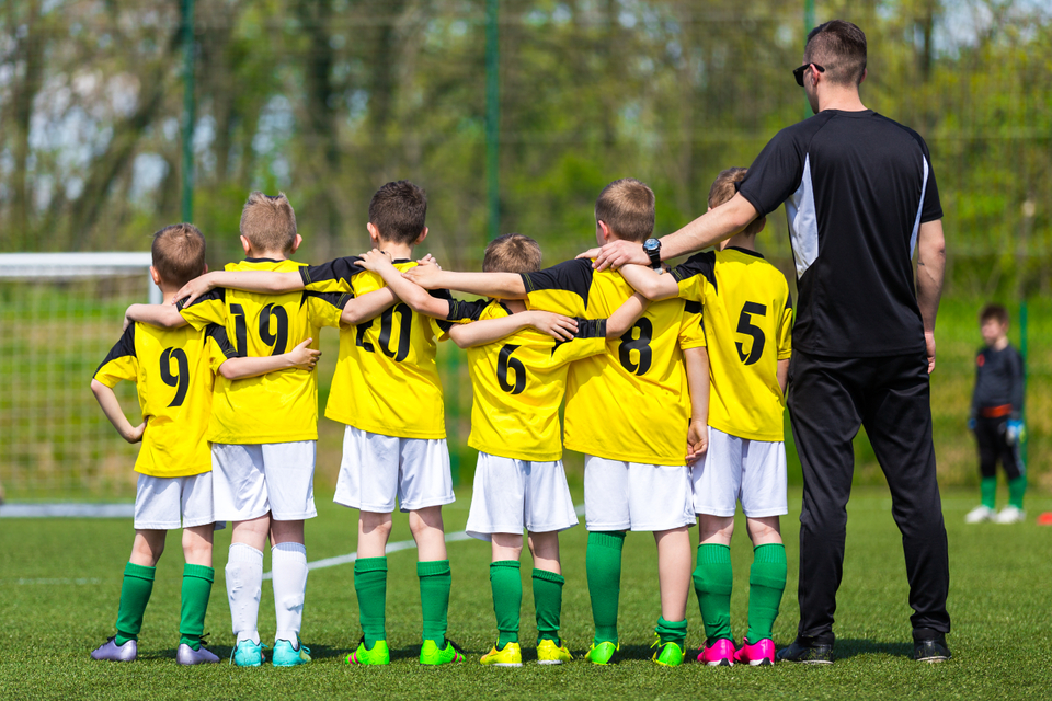 football coach talking with his team