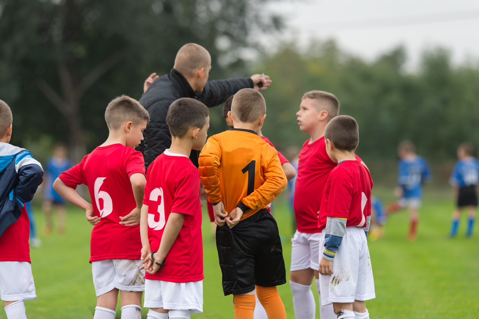 Coach with his grassroots football team