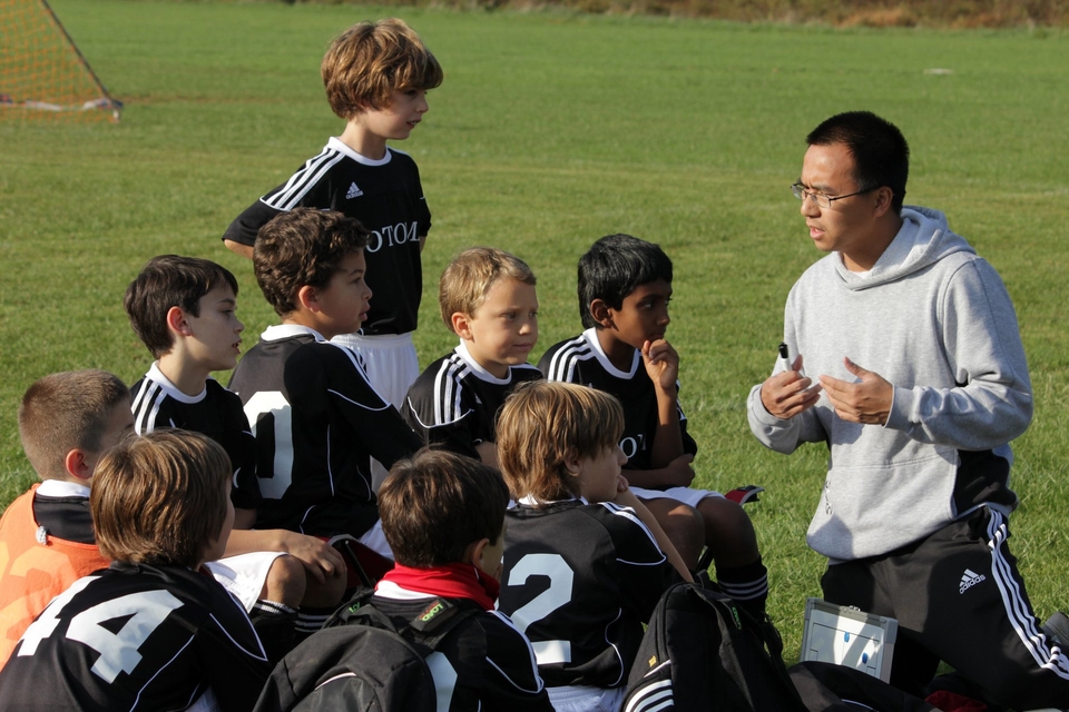Coach talking to his grassroots football team