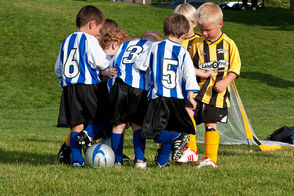 Young children playing grassroots football